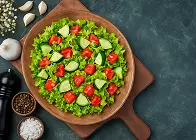 Fresh green salad with a mix of lettuce, tomato, cucumber